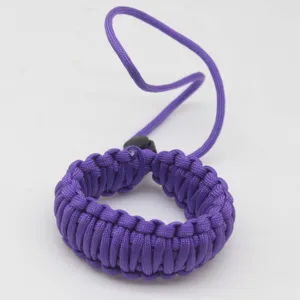 Detailed view of the purple woven paracord camera strap showing double-layer texture.