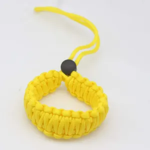 Detailed close-up of yellow woven paracord camera wrist strap showing fine texture and strong loop.