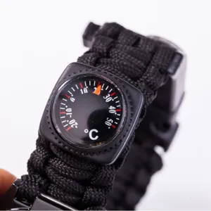 Black paracord survival bracelet with built-in thermometer for outdoor camping emergency.