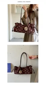 Close-up detail of retro brown polka dot suede tote bag featuring fluffy plush ball pendant.