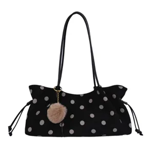 Black polka dot shoulder bag with fuzzy pom-pom charm and drawstring sides, daily tote.