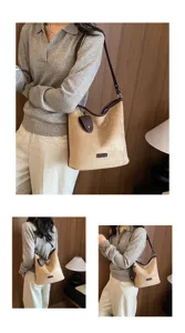 Detailed view of the stylish frosted shoulder bag with contrast trim and chic pendant.