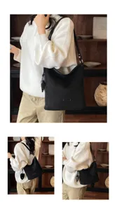 Women's minimalist black matte shoulder bag, casual bucket handbag detail view and wear.