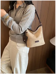 Chic retro suede shoulder bag for women, large capacity commuter bucket bag with stylish pendant.