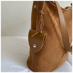 Brown suede bucket bag for women, stylish shoulder bag with spacious capacity and chic drawstring.