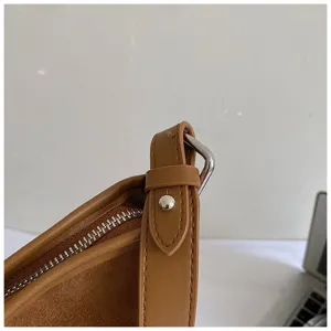 Brown PU leather shoulder bag detail shot featuring premium metal hardware and smooth zipper.