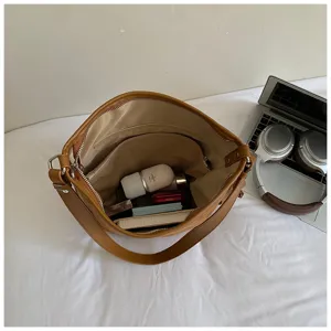 Stylish brown leather shoulder bag with large capacity, perfect for daily commute.