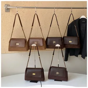 Chic brown shoulder bag detail featuring metal chain strap and elegant turn-lock closure.