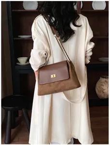 Detailed back view of a stylish brown contrast chain shoulder bag with a chic turn lock design.