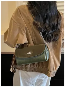 Detailed view of olive green retro shoulder bag with metallic twist lock and chic side scarf.