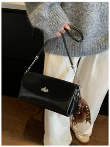 Minimalist black shoulder bag with chic metal lock and chain strap for women chic daily use.
