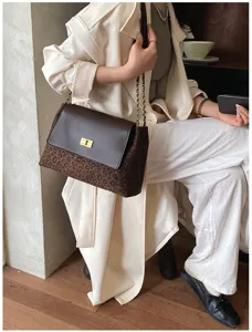 Fashion brown leopard print shoulder bag with metal chain strap and chic twist-lock closure.