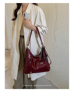 Burgundy faux leather slouchy shoulder bag detail shot, retro minimalist commuter handbag