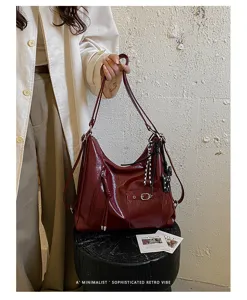 Retro wine red large capacity tote bag detail, featuring soft leather and chic metal hardware.