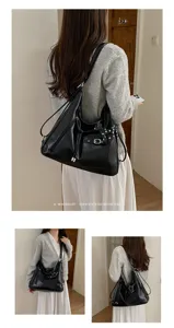 Detailed view of a stylish black PU leather hobo shoulder bag with large capacity and retro vibe.