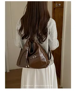 Detail shot of retro women's large capacity commuter shoulder bag and casual leather backpack.