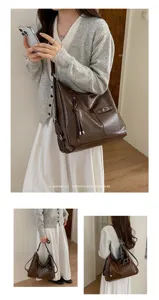 Detailed view of brown PU leather vintage tote bag, large capacity shoulder bag with multi details.
