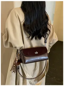 Chic minimalist brown shoulder bag with metal turn-lock and stylish strap for women everyday.