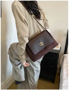 Stylish brown suede and leather shoulder bag with chic metal chain and double ring lock.