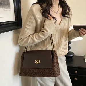 Fashionable leopard print shoulder bag with chain strap and metal lock closure ideal daily use.