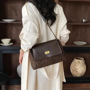 Chic leopard print shoulder bag with metal chain strap and elegant turn lock closure.