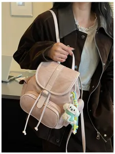 Stylish pink suede backpack for women, casual daily commute bag with cute puppy charm.