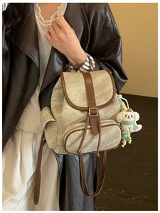 Casual women's canvas backpack with brown PU leather trim, stylish daily school bag.