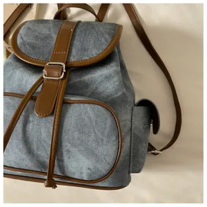 Casual denim backpack with brown PU leather trim, stylish daily commuting large capacity bag.