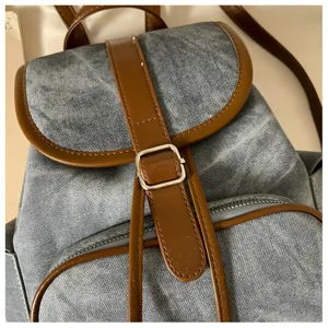 Denim backpack with brown leather trim, stylish casual daypack for women commuting, daily use.