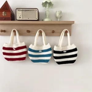 Knit stripe handbag detail featuring soft woolen material and cute mini style for kids.