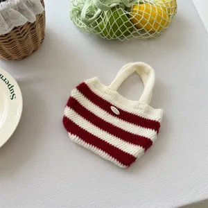 Close-up detail of the Korean style red and white striped knitted handbag for kids styling.