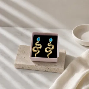 Vintage gold snake earrings with blue stone for women, chic niche design metal jewelry.