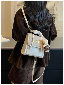 Chic small backpack for women, stylish daily commute travel bag with cute bear pendant.