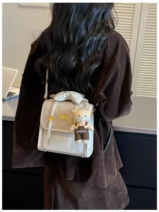 Trendy women small quilted backpack with elegant bow and cute bear pendant for daily commute