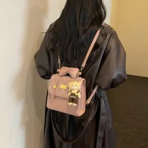 Chic pink women backpack with bow and bear pendant stylish autumn commute daily use bag.