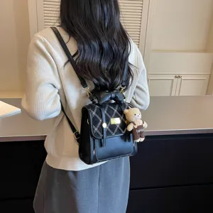 Stylish mini backpack for women, featuring chic plaid flap, bow decor and cute bear pendant.