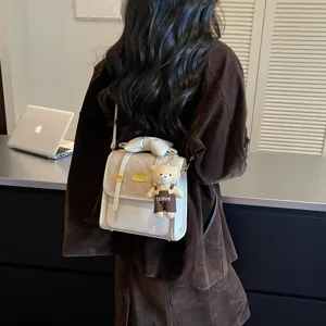 Chic mini backpack for women with bow and cute bear pendant, stylish daily commuting bag.