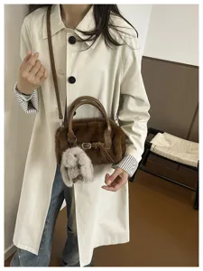 Brown plush fluffy crossbody pillow bag with cute bunny charm, stylish autumn winter accessory.