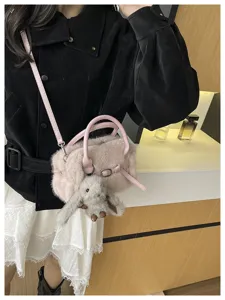 Winter fluffy plush shoulder bag for women, cute pink crossbody pillow bag with doll.