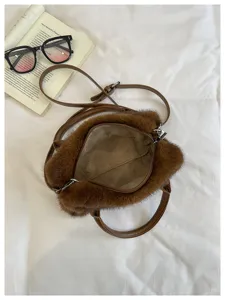 Brown fluffy crossbody pillow bag detail showing soft plush texture and spacious inner lining.