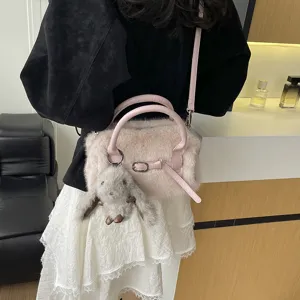 Stylish fluffy plush crossbody bag for women, cute winter shoulder pillow handbag with bunny charm.