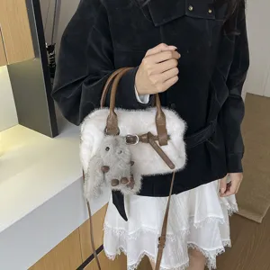 Winter fluffy plush crossbody bag for women, white faux fur pillow handbag with cute doll charm.