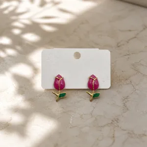 Exquisite pink enamel tulip earrings with green leaves, delicate metal jewelry detail view.