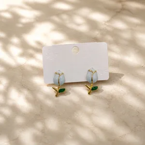 Delicate enamel tulip earrings detail shot, stylish gold stem floral design jewelry for women.