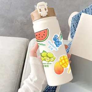 Close-up detail view of a white insulated water bottle featuring cute fruit stickers with text.