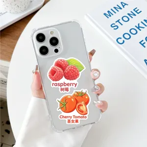 Clear phone case with cute fruit stickers featuring raspberry and tomato designs.