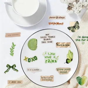 Detail shot of vintage green inspirational phrase waterproof stickers displayed on a white plate.