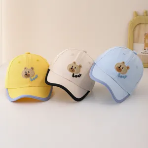 Detailed view of cute baby baseball hats featuring sweet cartoon bear embroidery and vibrant colors.