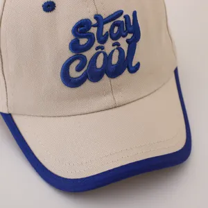 Cute beige kids baseball cap with blue trim and cool embroidered text detail design