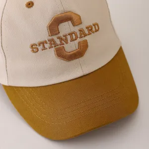 Close-up detail of infant baseball cap, cute embroidered letter design, spring autumn kids hat.